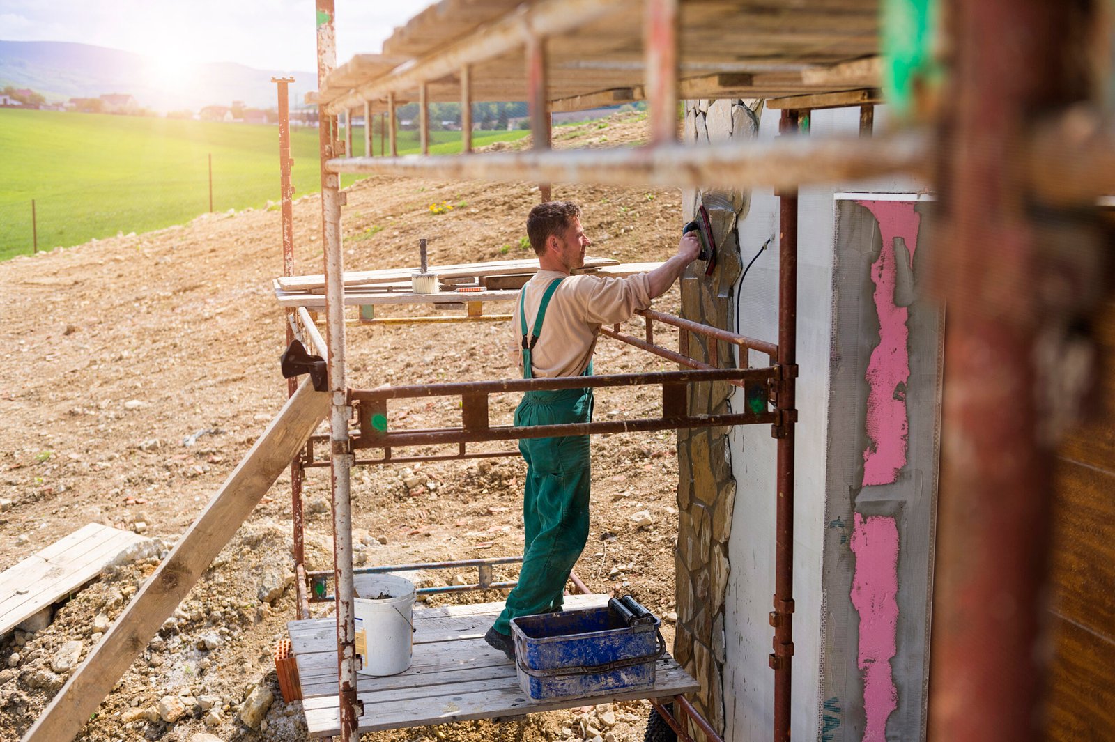 man putting natural stones on a wall 2026 03 10 02 12 38 utc scaled