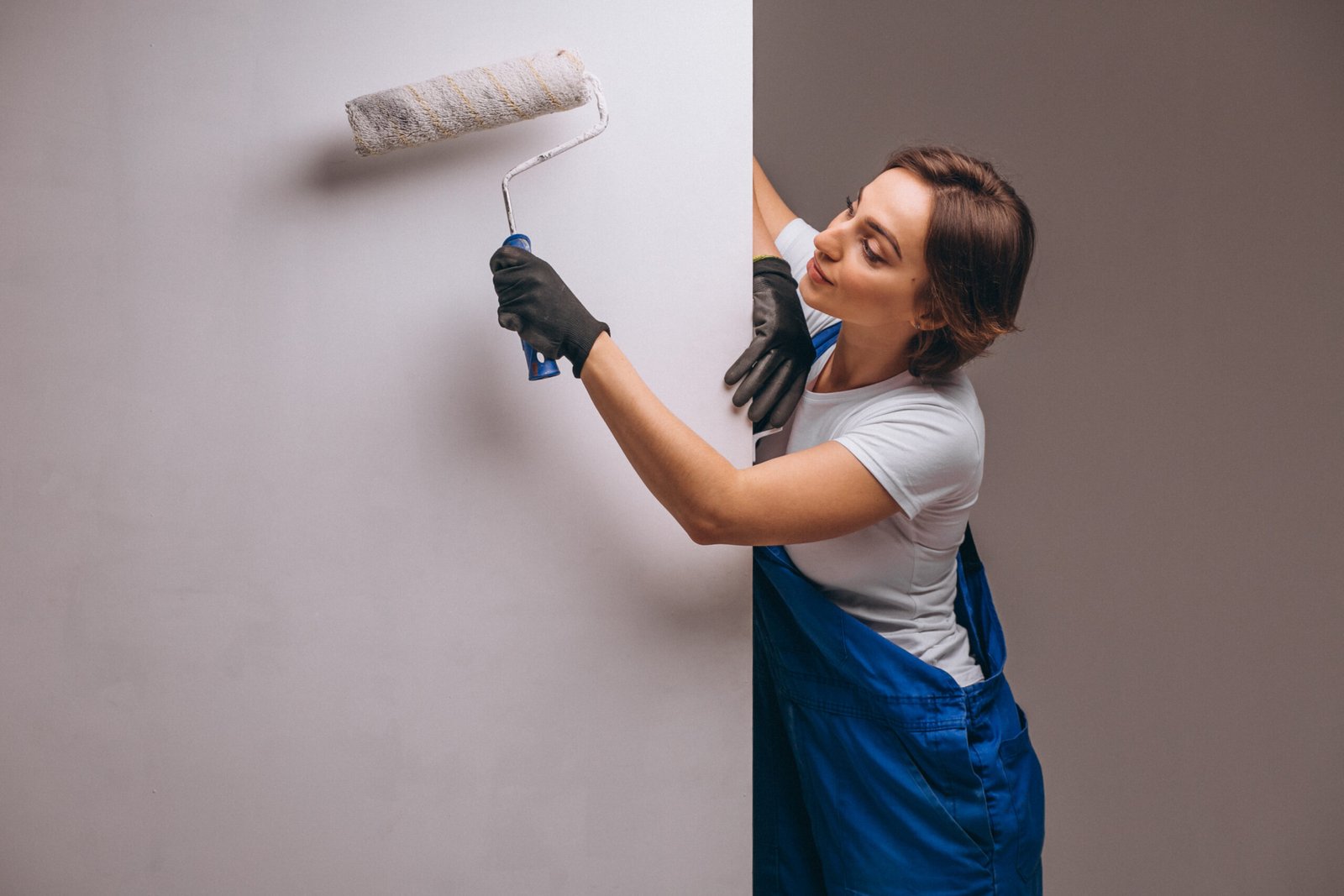 woman repairer with painting roller isolated 1 scaled